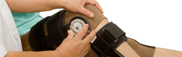 therapist adjusting leg brace